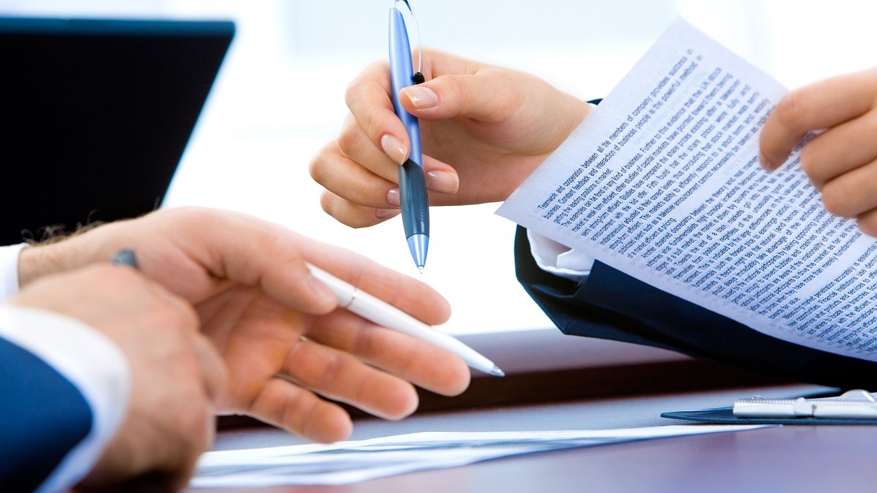 doctor reviewing documents at desk