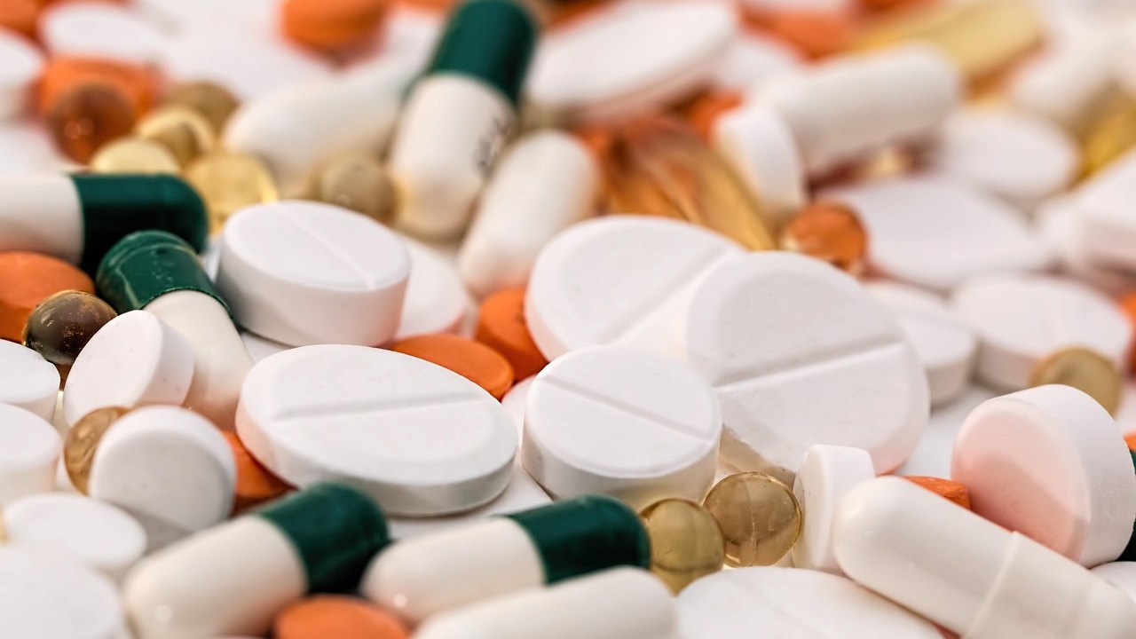 pharmacist holding antibiotic capsules