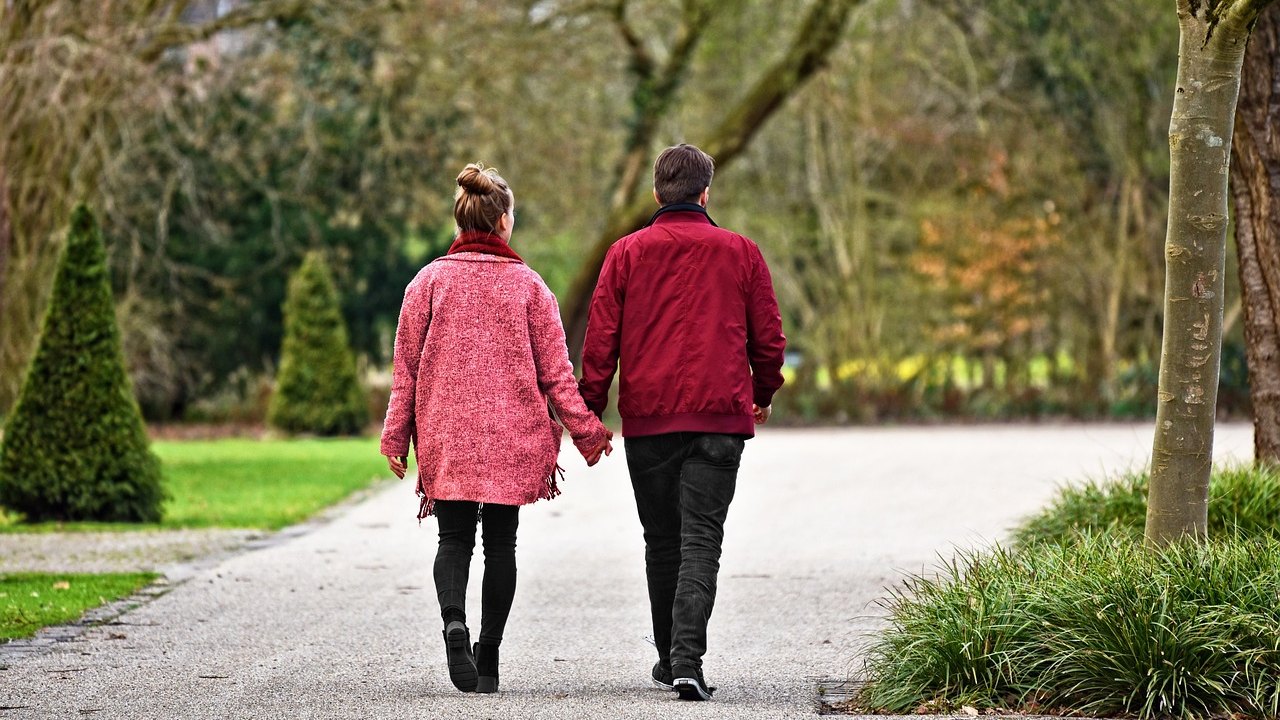 older adults walking in park outdoors