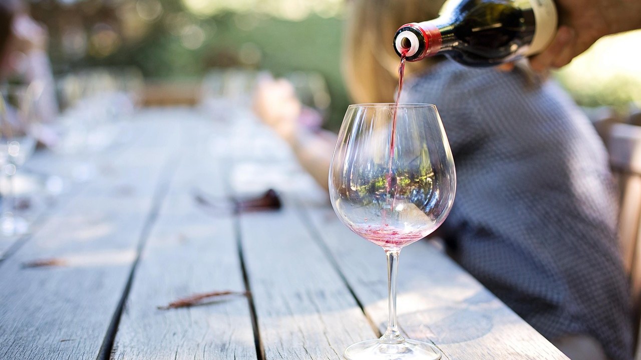 two glasses of red wine on a table