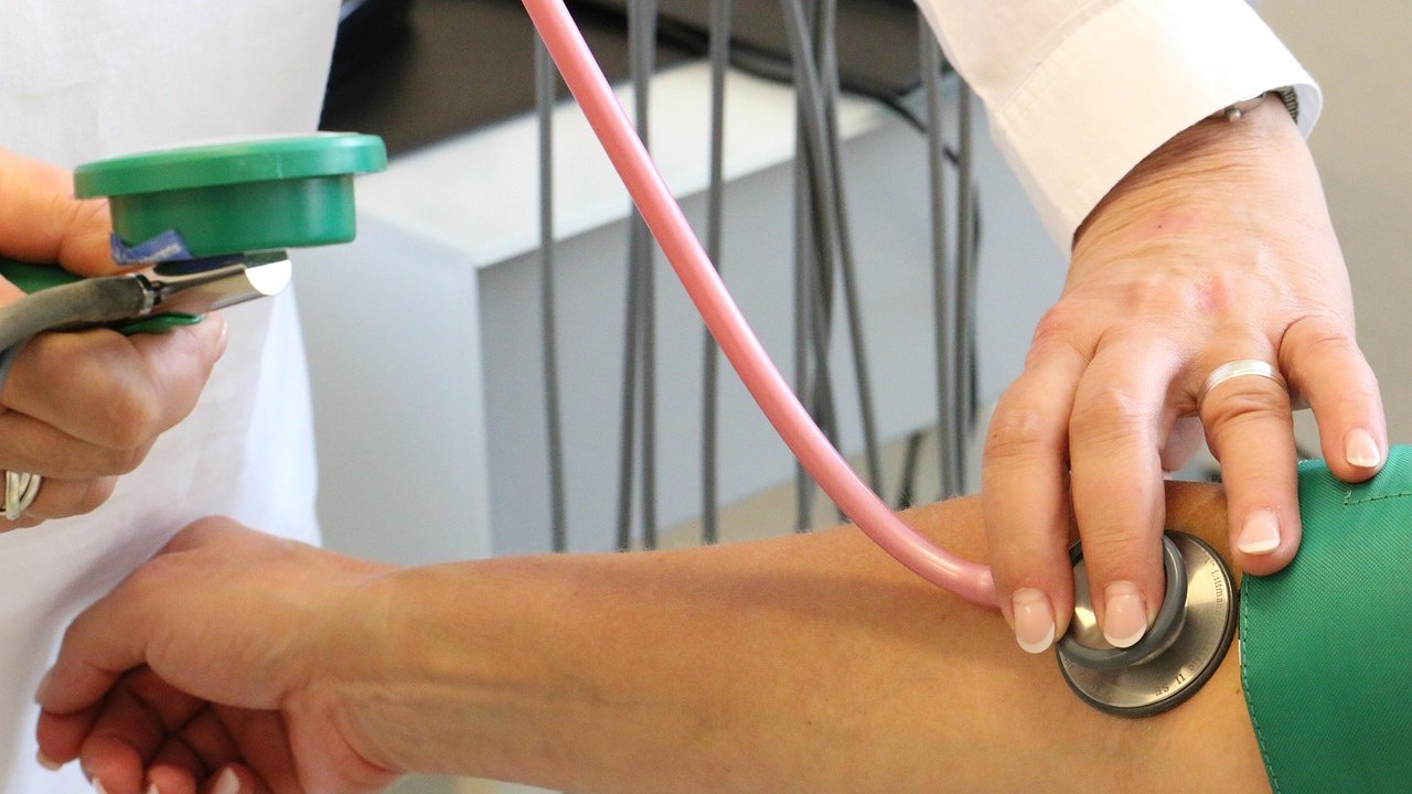 doctor measuring blood pressure cuff